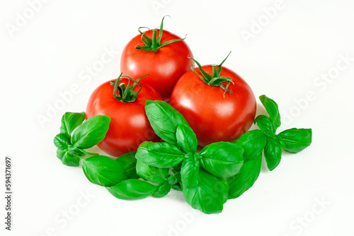 Tomatoes and basil leaves on a white background