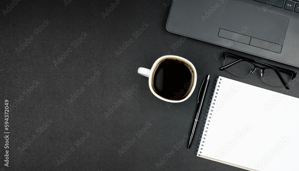 Desk workspace. Blank notepad, pen, glasses, laptop and coffee on dark table. Desk workspace. Blank notepad, pen, glasses, laptop and coffee on dark table.