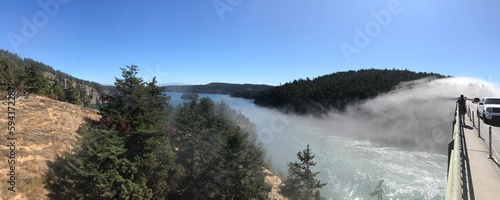 Deception Pass in Northern Washington State with a extremely rare Rainbow bridge arches over the Deception Pass Bridge. photo