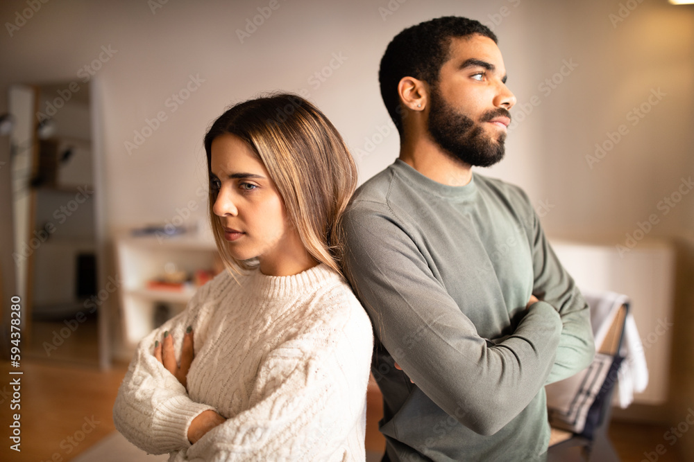 Obraz premium Angry offended millennial middle eastern boyfriend ignores european girlfriend back to back