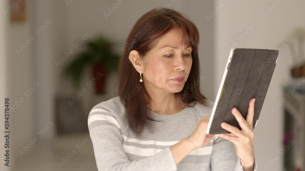 Stylish woman scrolling, reading, texting email communication on cellular mobile tablet Stylish woman scrolling, reading, texting email communication on cellular mobile tablet