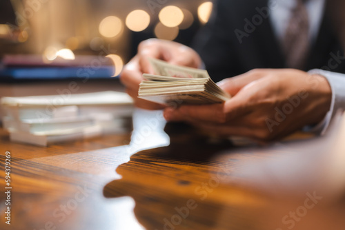 business hands holding dollar bank, Bookkeeper financial inspector checking a money to making calculating balance report, Home finances investment, saving and corruption or insurance economy concept.