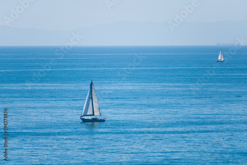 Sailboats in the Pacific Ocean off the coast of California with Caralina Island in the background