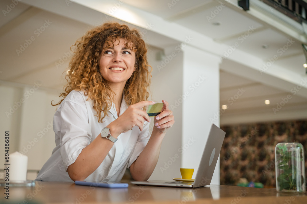 Woman happy caucasian female shopping online use credit card at cafe Woman happy caucasian female shopping online use credit card at cafe