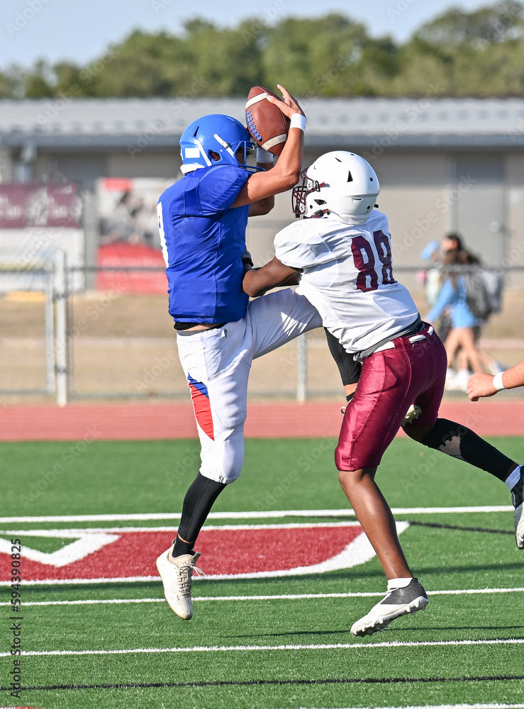 Young athletic young boys playing in a competitive game of tackle football and making incredible game winning plays Young athletic young boys playing in a competitive game of tackle football and making incredible game winning plays