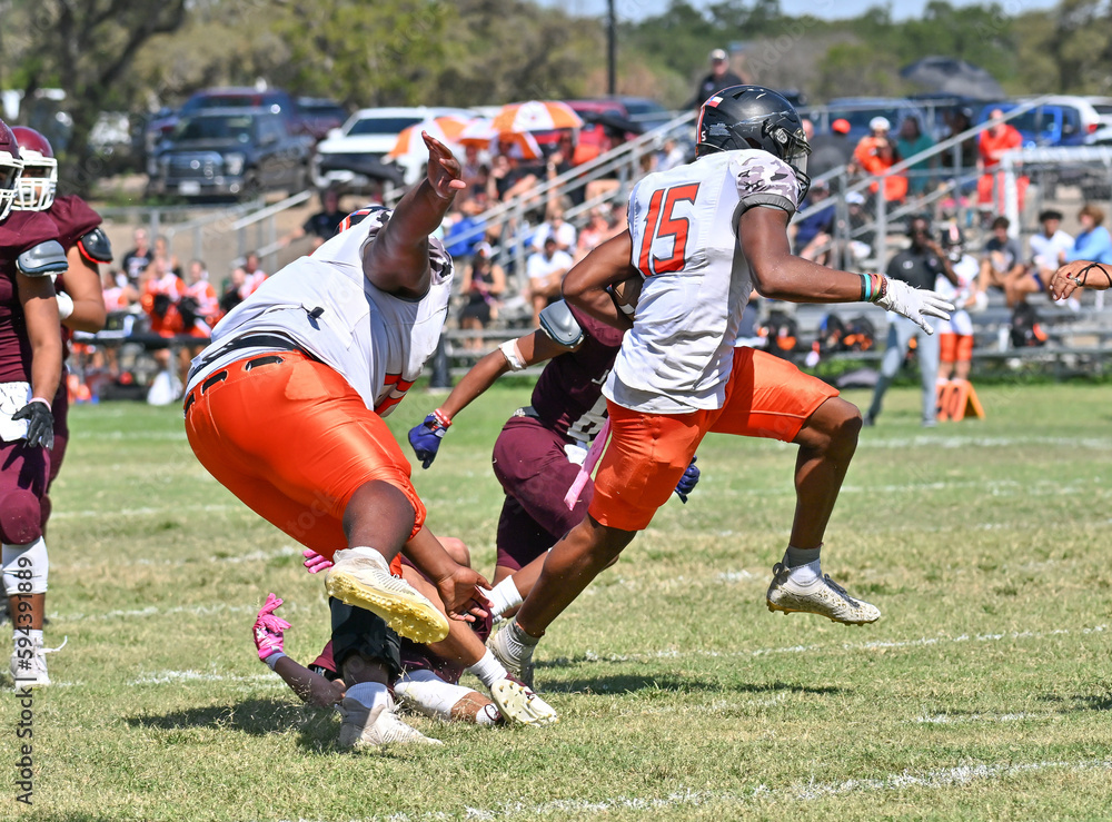 Young athletic young boys playing in a competitive game of tackle football and making incredible game winning plays Young athletic young boys playing in a competitive game of tackle football and making incredible game winning plays