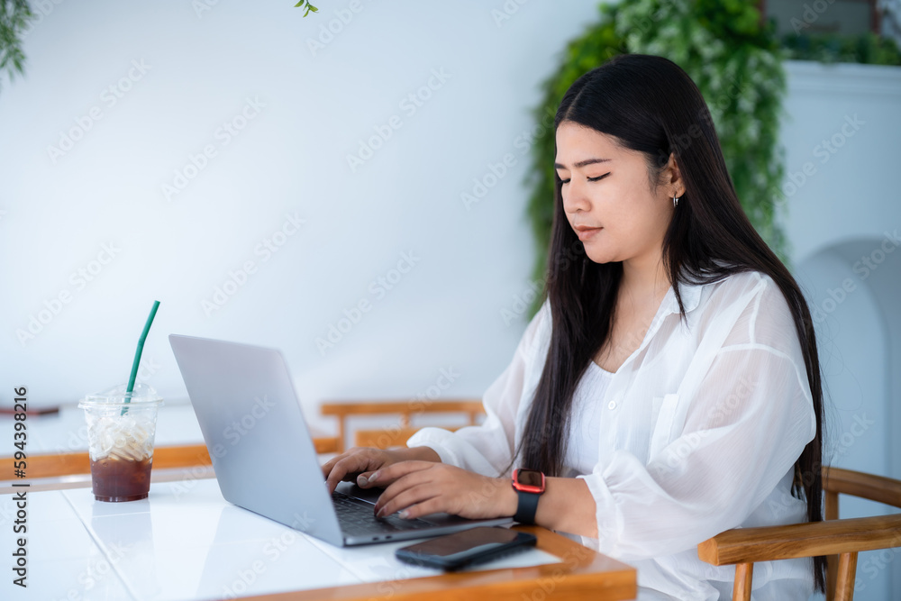 asian freelance people business female wearing smartwatch talking making using casual working with laptop computer for browsing internet, chatting and blogging and smartphone,notebook in coffee shop. asian freelance people business female wearing smartwatch talking making using casual working with laptop computer for browsing internet, chatting and blogging and smartphone,notebook in coffee shop.