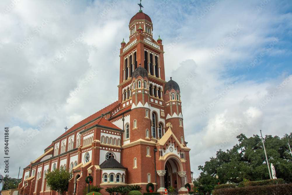 Fototapeta premium The historic Dutch Romanesque Revival style Cathedral of Saint John the Evangelist or La Cathedrale St-Jean built in 1916 on Cathedral Street in downtown Lafayette, Louisiana, USA