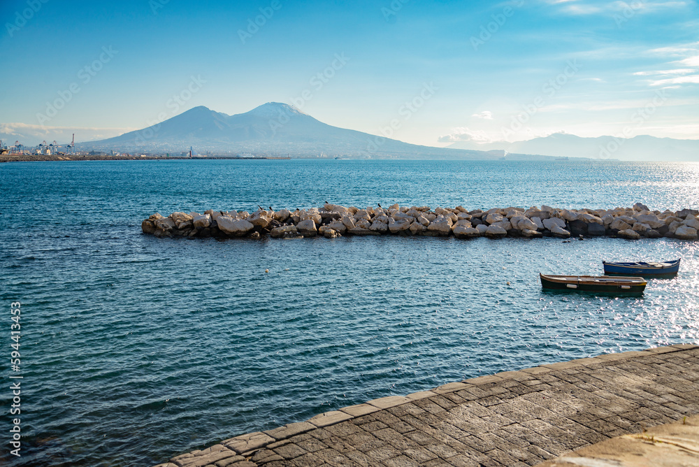 Vesuvius seen and fish boats from the seafront of Naples in Italy