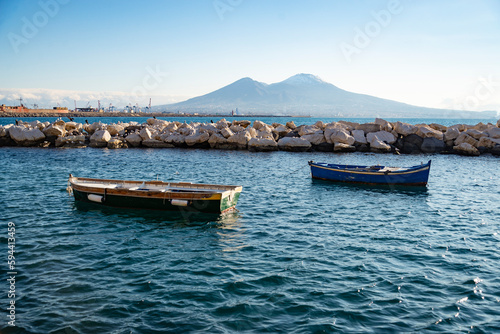 Vesuvius seen and fish boats from the seafront of Naples in Italy photo