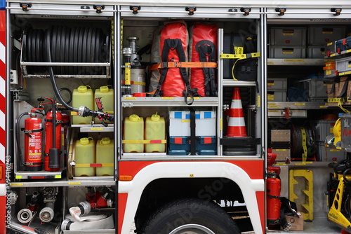 Inner compartment of fire truck with equipment - firehoses, fire extinguishers, cones, fire engine brigade