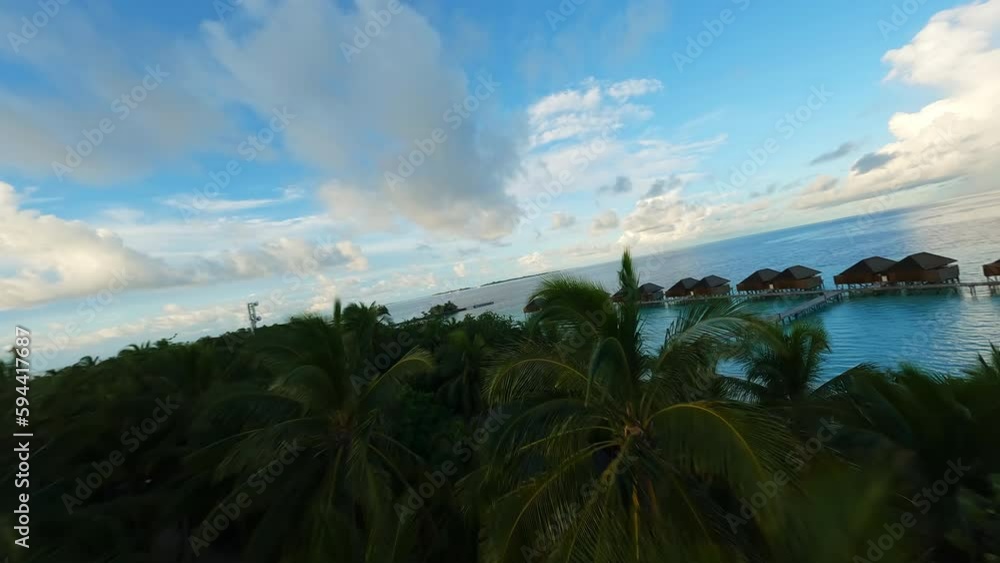 Hotel and houses on the water in the Maldives. Island with palm trees. Hotel and houses on the water in the Maldives. Island with palm trees.