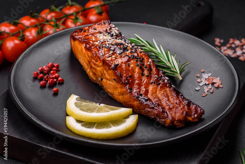 Delicious grilled red salmon fish with sauce, sesame seeds, spices and herbs