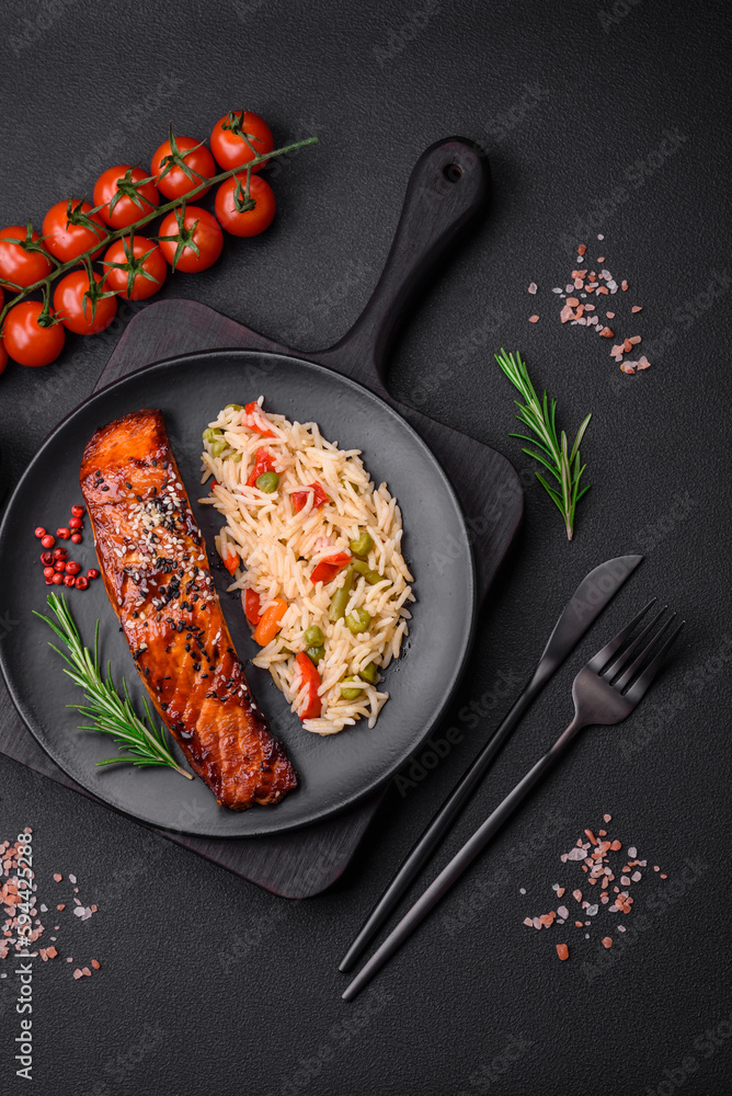 Delicious red salmon fish grilled with sauce and sesame seeds with rice and vegetables Delicious red salmon fish grilled with sauce and sesame seeds with rice and vegetables