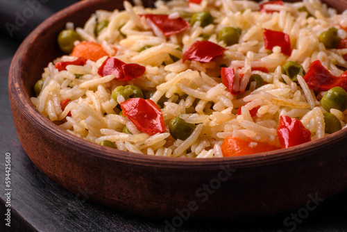 Delicious boiled rice with vegetables peppers, carrots, peas and asparagus beans