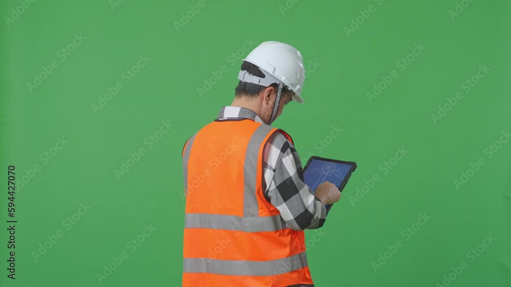 Back View Of Asian Male Engineer With Safety Helmet Looking At The Wind Turbine Blueprint On A Tablet While Standing In The Green Screen Background Studio
Back View Of Asian Male Engineer With Safety Helmet Looking At The Wind Turbine Blueprint On A Tablet While Standing In The Green Screen Background Studio