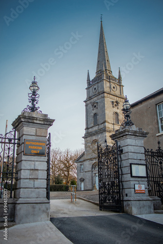 Gate of entrance to peter's church in Drogheda, Ireland on a sunny morning in spring. Massive metal door in front of majestic church.