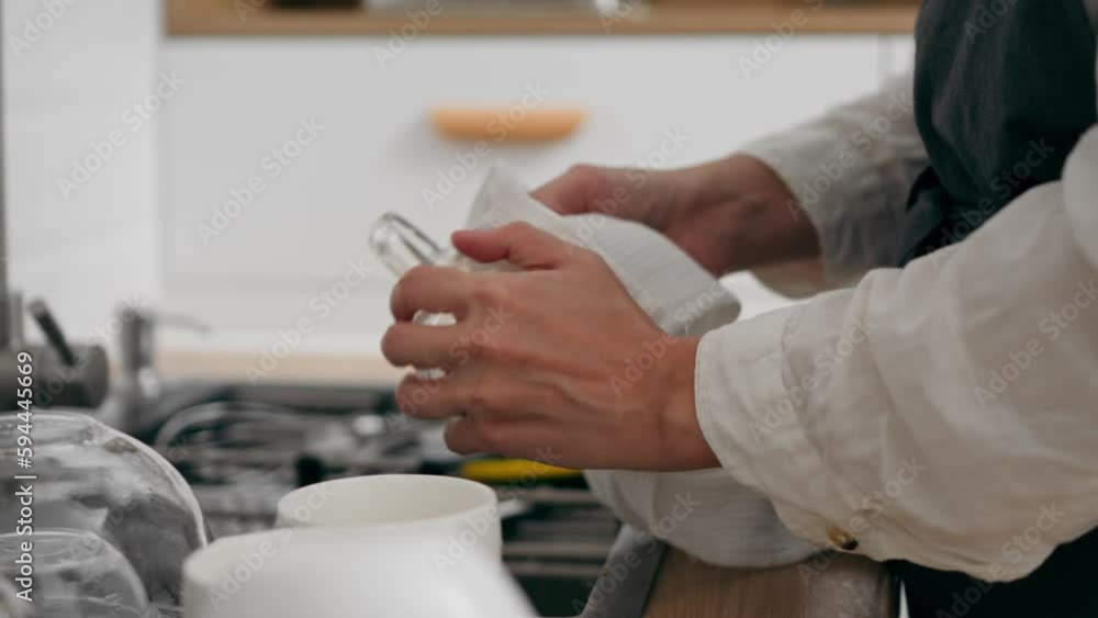 A young white housewife with experience wipes freshly washed dishes from water and drips. Cleaning in the kitchen of a city apartment, Female hands wipe a white plate with a kitchen towel
A young white housewife with experience wipes freshly washed dishes from water and drips. Cleaning in the kitchen of a city apartment, Female hands wipe a white plate with a kitchen towel