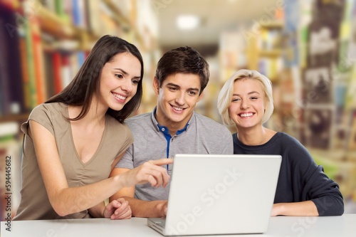 Cheerful happy student girl learning with laptop