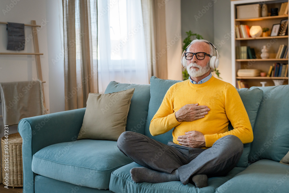 Mature senior man practice guided meditation manifestation at home Mature senior man practice guided meditation manifestation at home