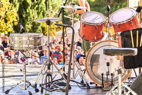 Summer music festival at the park. Drums on the stage while audience is waiting for the band to play