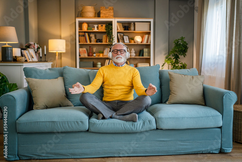 Mature senior man practice guided meditation manifestation at home