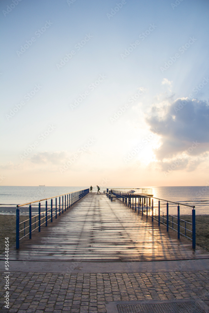 Beautiful view of the wooden pier that leads to the sea