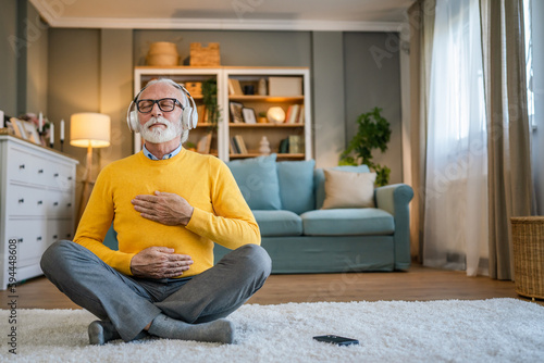 Fototapete Mature senior man practice guided meditation manifestation at home