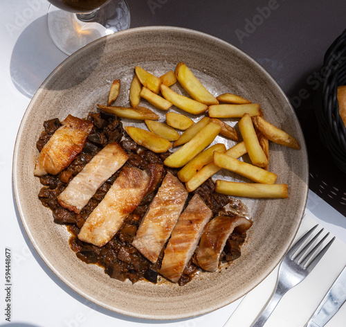 Iberian pork in sweet wine with stewed vegetables. Spanish dish