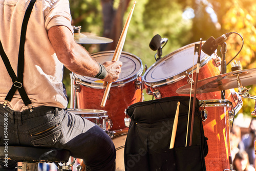 Fototapeta Naklejka Na Ścianę i Meble -  Summer music festival at the park. Close up of drummer playing on the stage