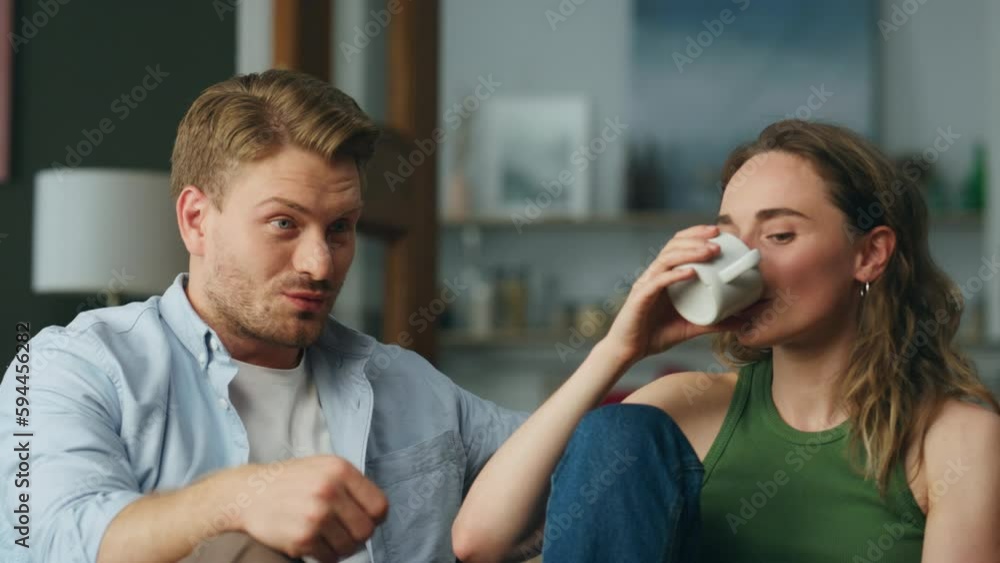 Talking duet drinking tea at sofa interior closeup. Calm woman sipping coffee Talking duet drinking tea at sofa interior closeup. Calm woman sipping coffee