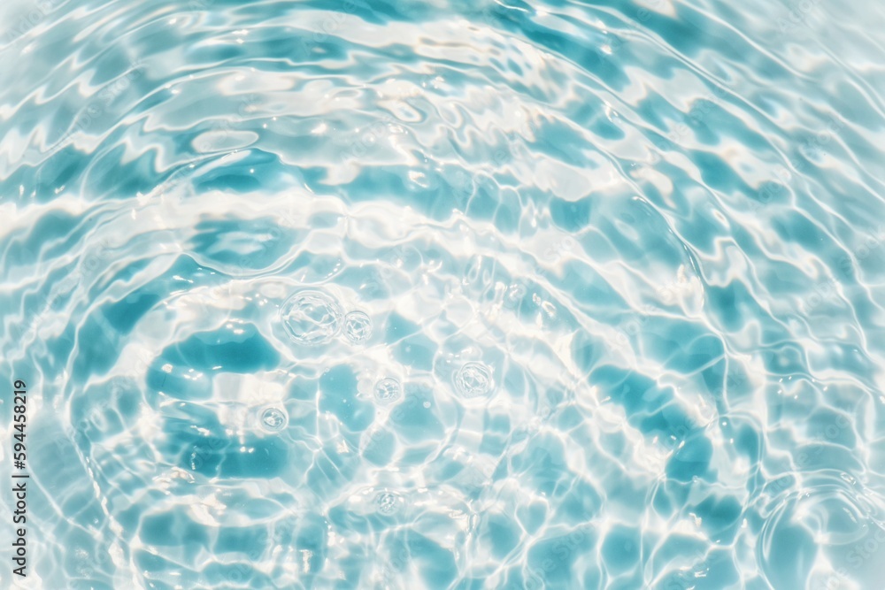 Blue water with ripples on the surface. Defocus blurred transparent blue colored clear calm water surface texture with splashes and bubbles. Water waves with shining pattern texture background texture