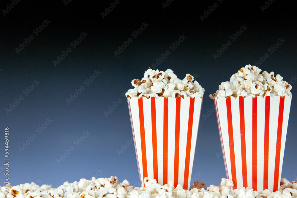 front view fresh popcorn in white and red striped packages on dark background snack cinema cips color photo corn movies