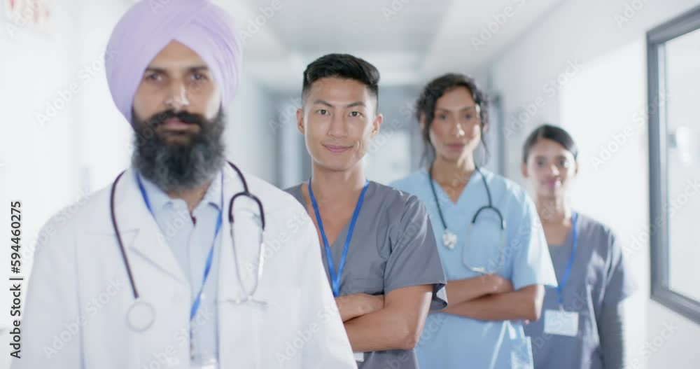Portrait of diverse doctors and nurses smiling in corridor at hospital, in slow motion Portrait of diverse doctors and nurses smiling in corridor at hospital, in slow motion