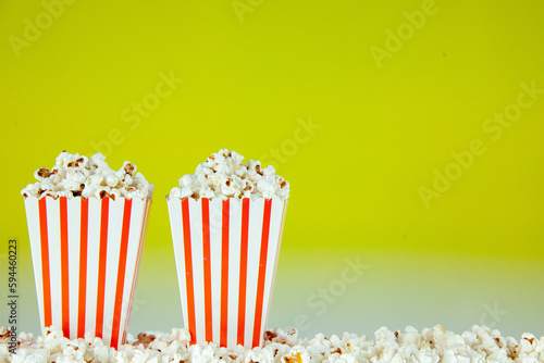 front view fresh popcorn in white and red striped packages on light green background snack cinema cips color photo corn movie free space