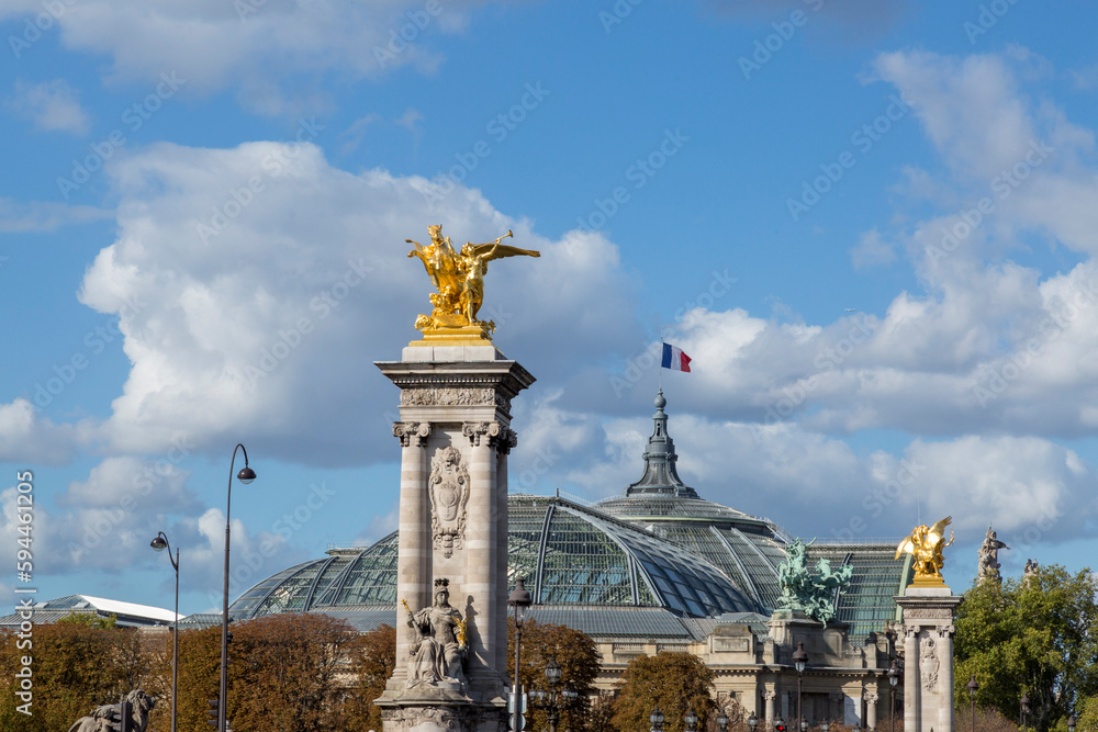 Paris. Statues at Pont Alexandre III, along River Seine. Grand Palais in background.