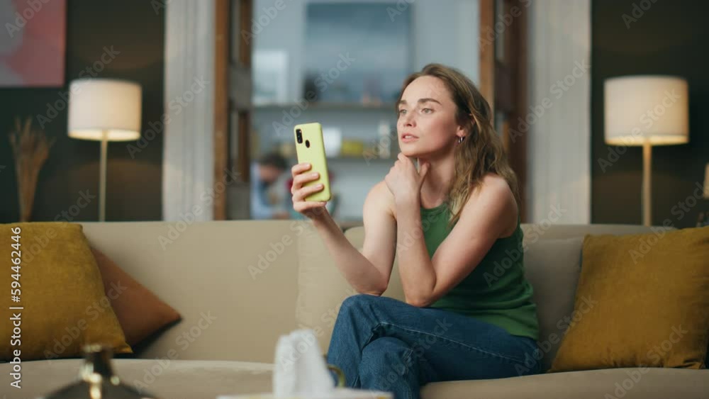 Serious businesswoman talking smartphone at home office. Lady having video chat Serious businesswoman talking smartphone at home office. Lady having video chat