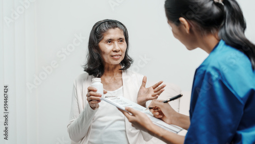 Senior older elderly patient asian grandmother woman with nurse consulting, safety and support of help, trust of breast cancer awareness, encourage