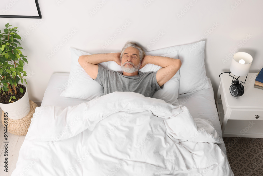 Senior man sleeping in bed at home Senior man sleeping in bed at home