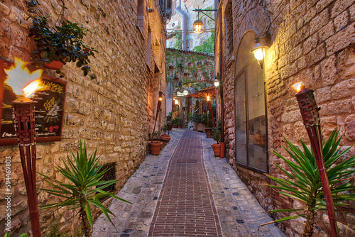 Italy  Umbria. Street lined with flower pots in the town of Assisi.