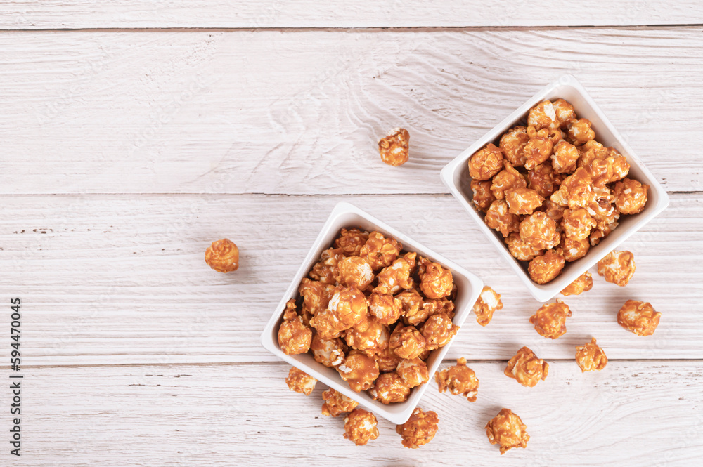 Top view of Caramel popcorn with candy on wood table background. Top view of Caramel popcorn with candy on wood table background.