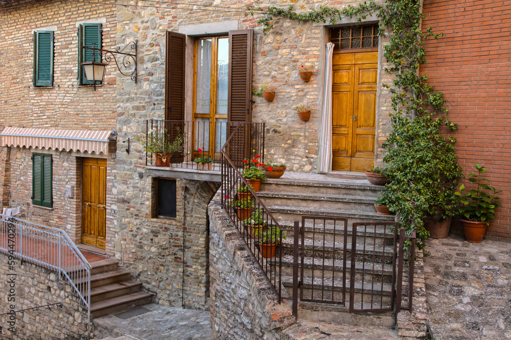 Italy, Umbria. Stairs lined with flowering pots leading to homes in the historic town of Montone.