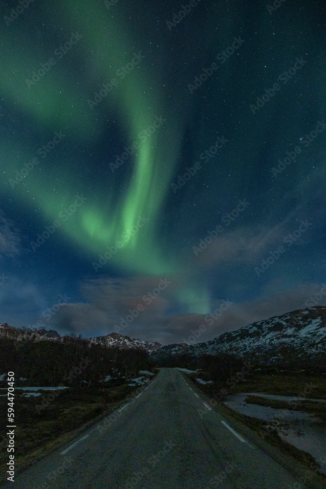 Norway, Lofoten Islands. Aurora Borealis above the road to Nusfjord