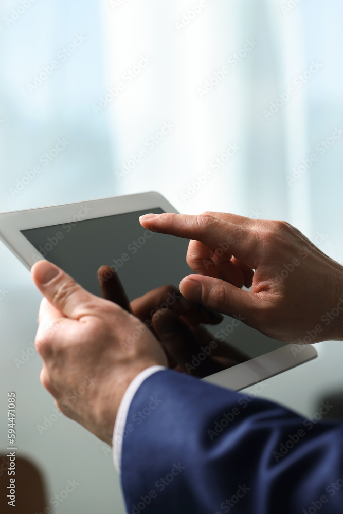 Closeup view of man using new tablet indoors