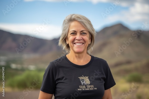 Portrait of a beautiful senior woman smiling in a desert landscape.