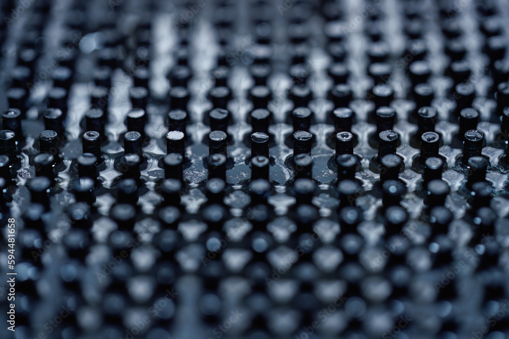 Close up of dark black peg repeating pattern Close up of dark black peg repeating pattern