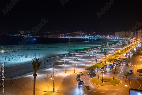 View of the coastline with Tangier city at night illuminated, Tangier, Morocco