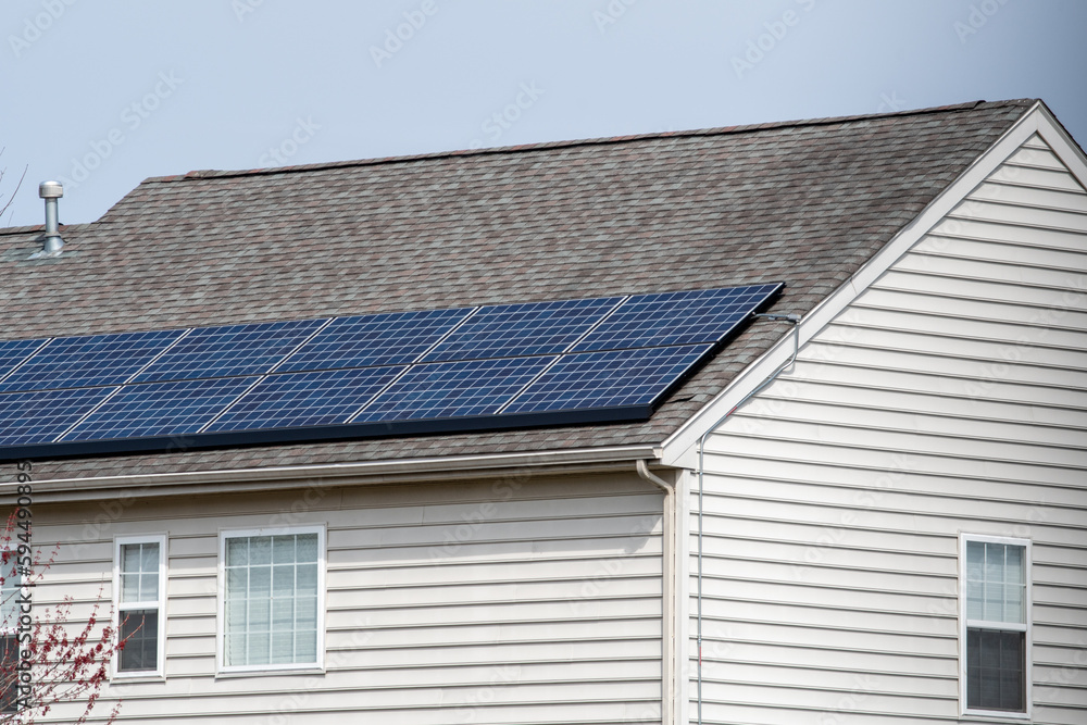 Solar photovoltaic panels on a house roof Solar photovoltaic panels on a house roof