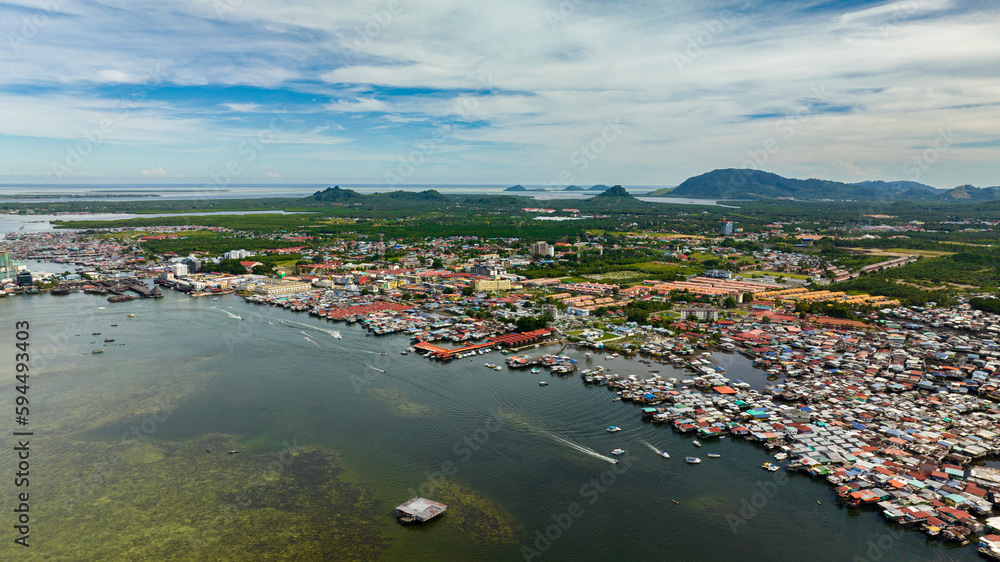 Aerial drone of traditional stilt houses of poor people in the town of Semporna. Borneo, Sabah, Malaysia.