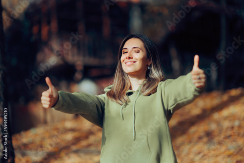 Happy Cheerful Woman Holding Thumbs Up Enjoying Vacation. Lady recommending a bed and breakfast recreation in rural destination
 photo